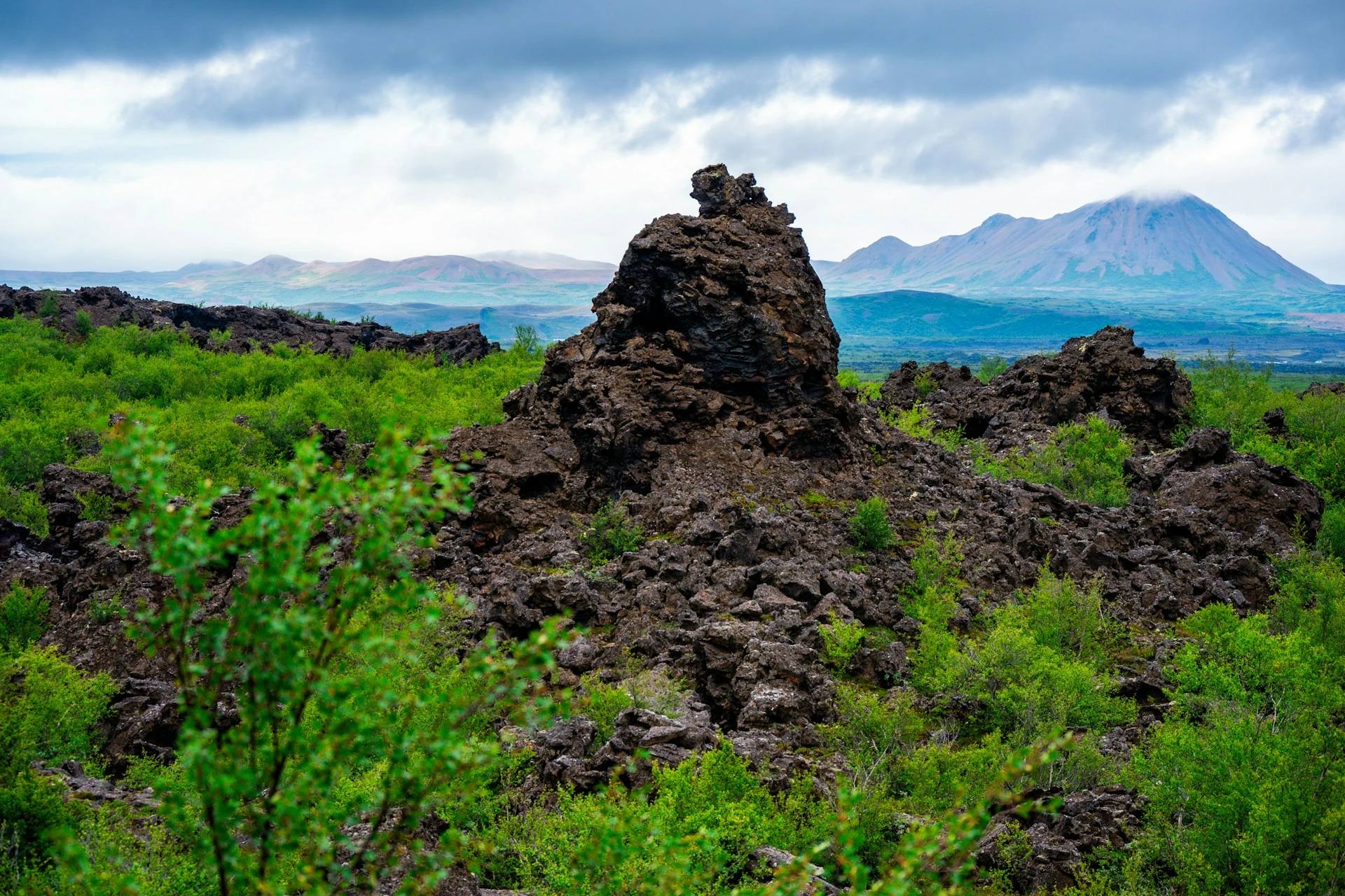 Volcanic formations poke through bushes close to Lake Mývatn