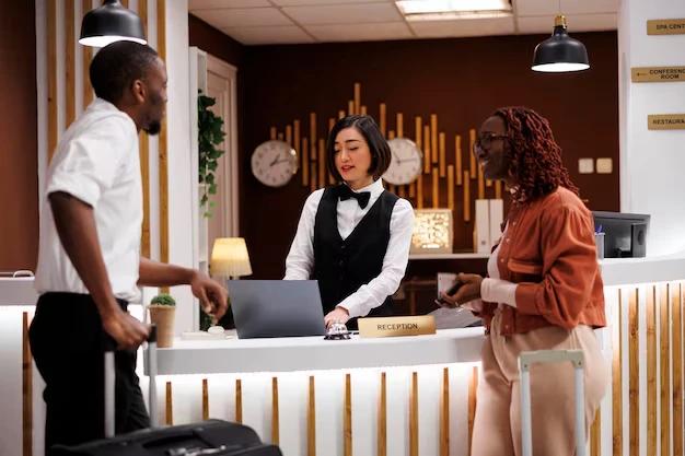 A hotel receptionist with visitors.