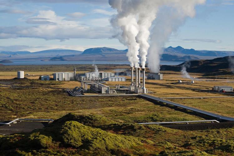 Nesjavellir geothermal power plant in Iceland with steam rising, showcasing the sustainable energy production that is used for heating houses across the country