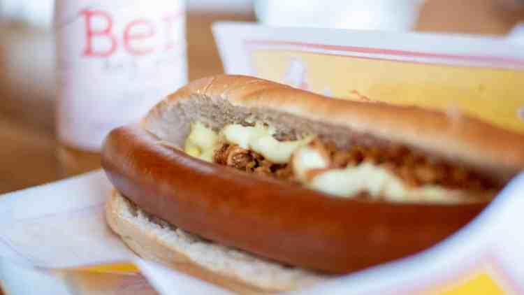 A delicious Icelandic hot dog, or Pylsur, topped with traditional condiments including remoulade, sweet mustard, and crispy onions. This image captures the essence of Iceland's favorite street food, a must-try for visitors.